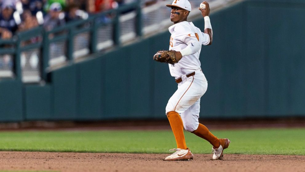 Texas shortstop Trey Faltine throws to first for an out against Notre Dame during the ninth inning of an NCAA College World Series baseball game Friday, June 17, 2022, in Omaha, Neb. (AP Photo/John Peterson)