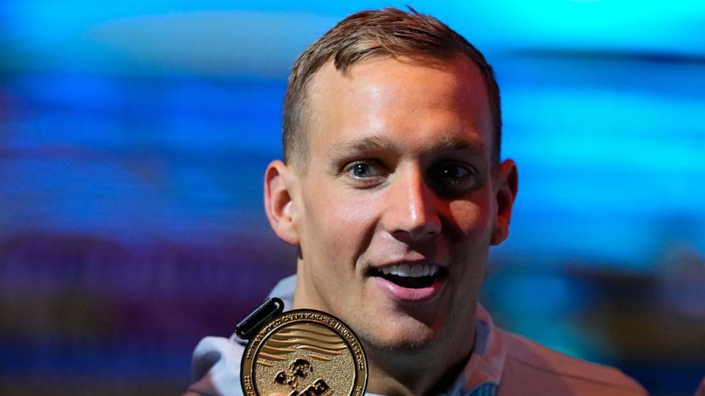 Caeleb Dressel of the United States poses with his medal after winning the Men 50m Butterfly final at the 19th FINA World Championships in Budapest, Hungary, Sunday, June 19, 2022. (AP Photo/Petr David Josek)