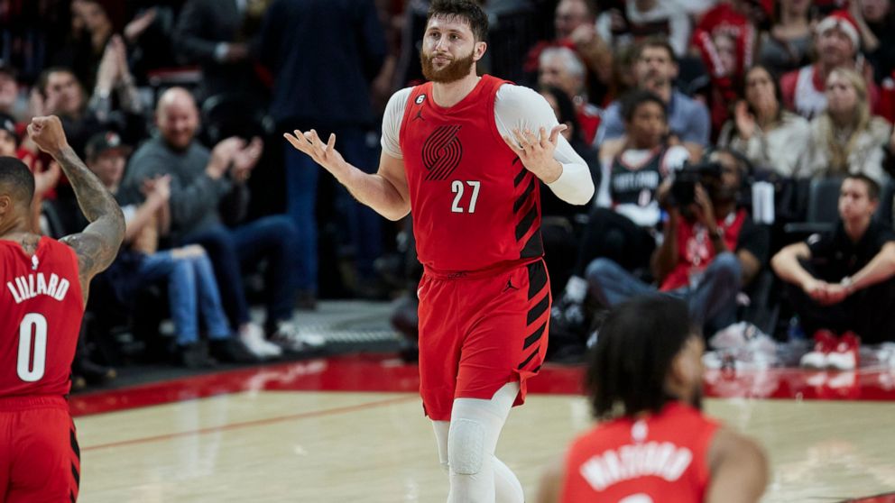 Portland Trail Blazers center Jusuf Nurkic (27) gestures after making a 3-point basket against the Charlotte Hornets during the second half of an NBA basketball game in Portland, Ore., Monday, Dec. 26, 2022. (AP Photo/Craig Mitchelldyer)