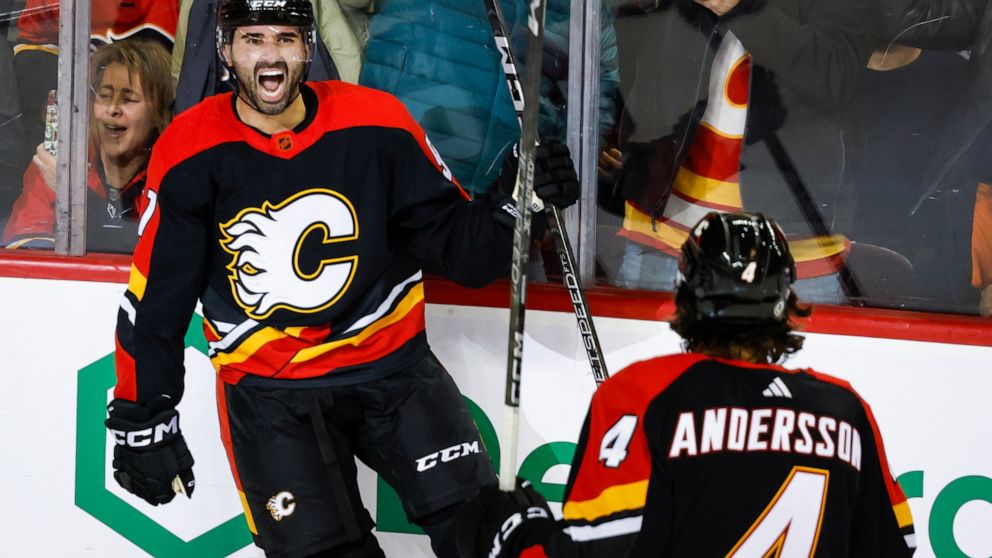 Calgary Flames forward Nazem Kadri, left, celebrates his goal with teammate Rasmus Andersson during the third period of an NHL hockey game against the Arizona Coyotes in Calgary, Alberta, Monday, Dec. 5, 2022. (Jeff McIntosh/The Canadian Press via AP)
