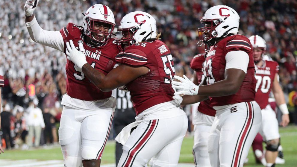 South Carolina's Tonka Hemingway (91) celebrates with Jakai Moore (55) after rushing for a 2-point conversion during the first half of the team's NCAA college football game against South Carolina State on Thursday, Sept. 29, 2022, in Columbia, S.C. (