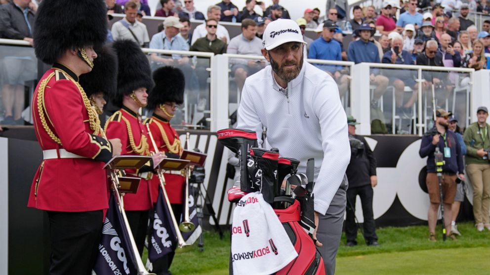 Dustin Johnson of the United States prepares to play from the first tee during the first round of the inaugural LIV Golf Invitational at the Centurion Club in St. Albans, England, Thursday, June 9, 2022. (AP Photo/Alastair Grant)