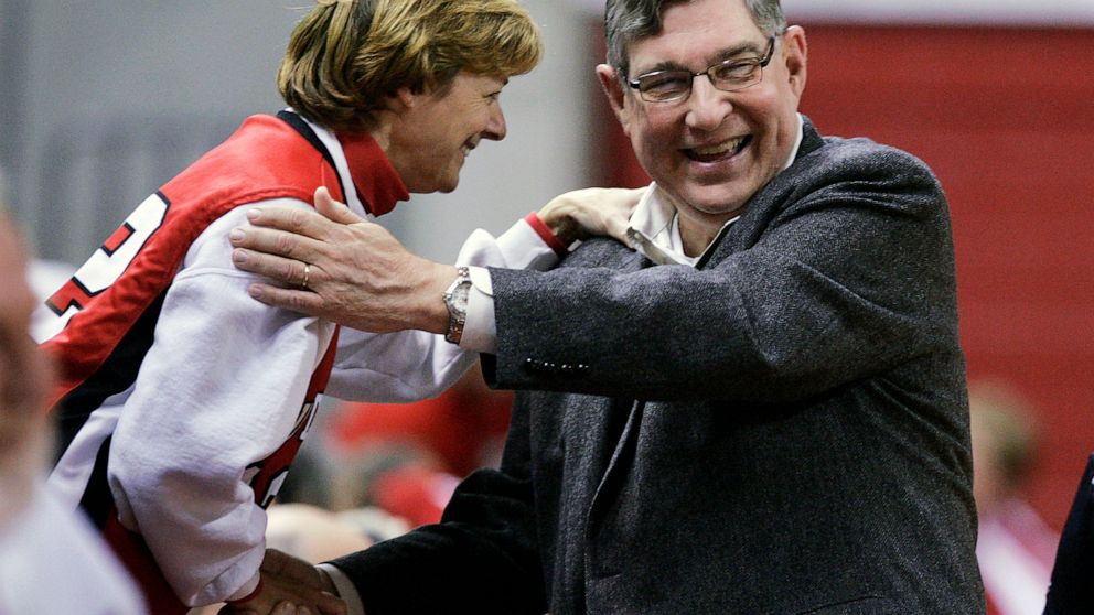 FILE - Rutgers athletic director Robert E. Mulcahy III, right, is greeted by a supporter Thursday, Dec. 11, 2008, in Piscataway, N.J., before a women's basketball game. Mulcahy, who served as athletics director for the state’s flagship university and