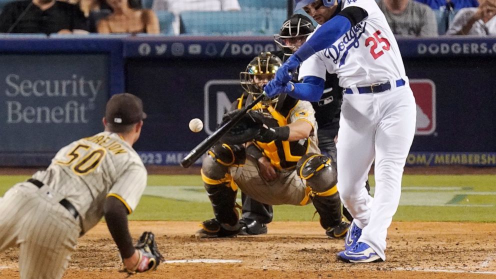 Los Angeles Dodgers' Trayce Thompson, right, hits a three-run home run as San Diego Padres relief pitcher Adrian Morejon, left, watches along with catcher Austin Nola during the seventh inning of a baseball game Sunday, Sept. 4, 2022, in Los Angeles.