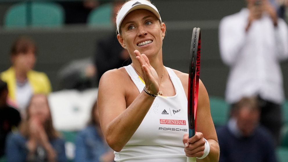 FILE - Germany's Angelique Kerber waves after defeating France's Kristina Mladenovic during their women's singles tennis match on day one of the Wimbledon tennis championships in London, Monday, June 27, 2022. Three-time Grand Slam champion Angelique