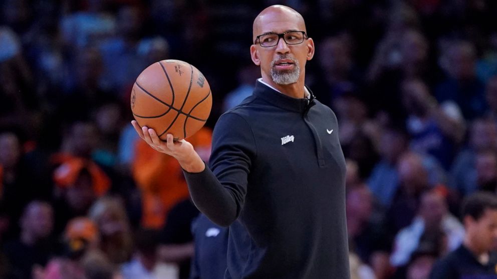 Phoenix Suns head coach Monty Williams hands off the ball during a break in the action during the first half of Game 2 in the second round of the NBA Western Conference playoff series against the Dallas Mavericks, Wednesday, May 4, 2022, in Phoenix. 