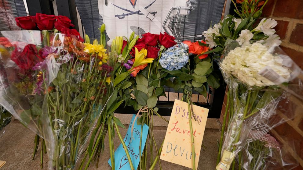 Memorial flowers and notes line walkway at Scott Stadium after three football players were killed in a shooting on the grounds of the University of Virginia Tuesday Nov. 15, 2022, in Charlottesville. Va. Authorities say three people have been killed 