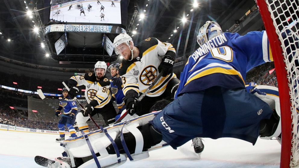 Boston Bruins center Charlie Coyle (13) scores a goal against St. Louis Blues goaltender Jordan Binnington (50) during the first period in Game 4 of the NHL hockey Stanley Cup Final Monday, June 3, 2019, in St. Louis. (Bruce Bennett/Pool via AP)