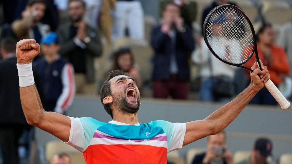 Croatia's Marin Cilic celebrates winning his quarterfinal match against Russia's Andrey Rublev in five sets, 5-7, 6-3, 6-4, 3-6, 7-6 (10-2), at the French Open tennis tournament in Roland Garros stadium in Paris, France, Wednesday, June 1, 2022. (AP 