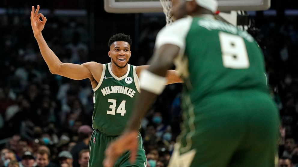 Milwaukee Bucks forward Giannis Antetokounmpo, left, celebrates after center Bobby Portis, right, scored during the second half of an NBA basketball game against the Los Angeles Clippers Sunday, Feb. 6, 2022, in Los Angeles. (AP Photo/Mark J. Terrill)