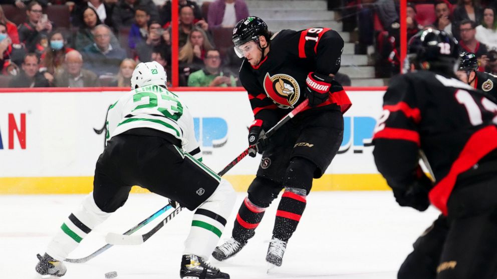 Ottawa Senators right wing Drake Batherson (19) moves the puck around Dallas Stars defenseman Esa Lindell (23) during second-period NHL hockey game action in Ottawa, Ontario, Monday, Oct. 24, 2022. (Sean Kilpatrick/The Canadian Press via AP)