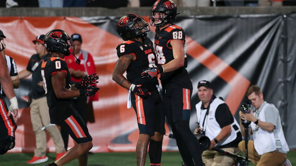 Oregon State tight end Luke Musgrave (88) celebrates his touchdown with Damien Martinez (6) and Tre'Shaun Harrison (0) during the first half of the team's NCAA college football game against Boise State on Saturday, Sept. 3, 2022, in Corvallis, Ore. (