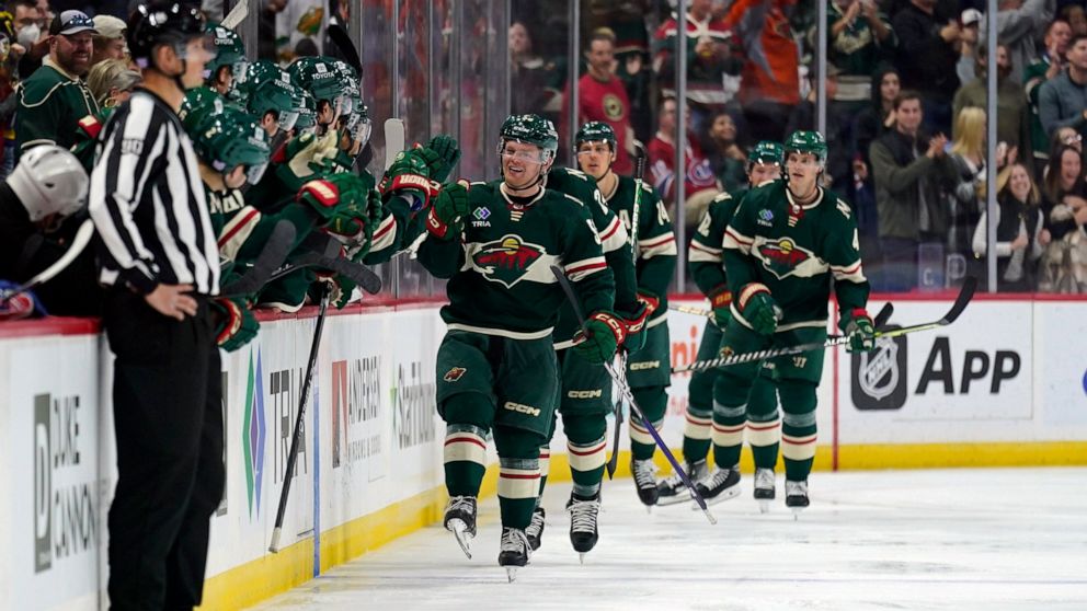 Minnesota Wild center Mason Shaw (58) celebrates with teammates after scoring a goal during the second period of an NHL hockey game against the Montreal Canadiens, Tuesday, Nov. 1, 2022, in St. Paul, Minn. (AP Photo/Abbie Parr)