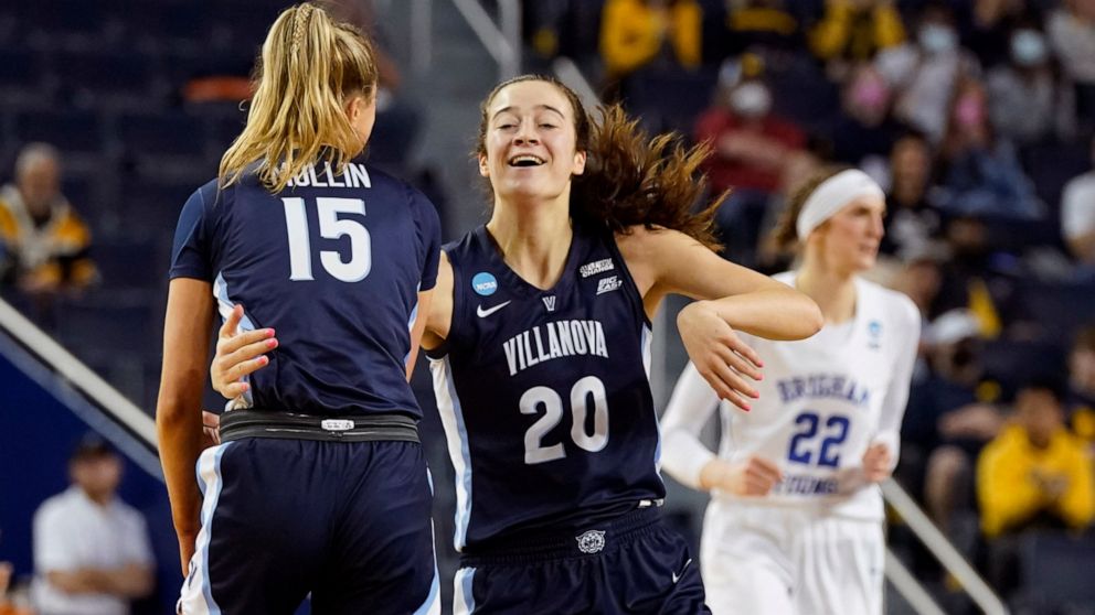 Villanova forward Maddy Siegrist (20) celebrates her 3-point basket with guard Brooke Mullin (15) during the second half of a college basketball game in the first round of the NCAA tournament against BYU, Saturday, March 19, 2022, in Ann Arbor, Mich.