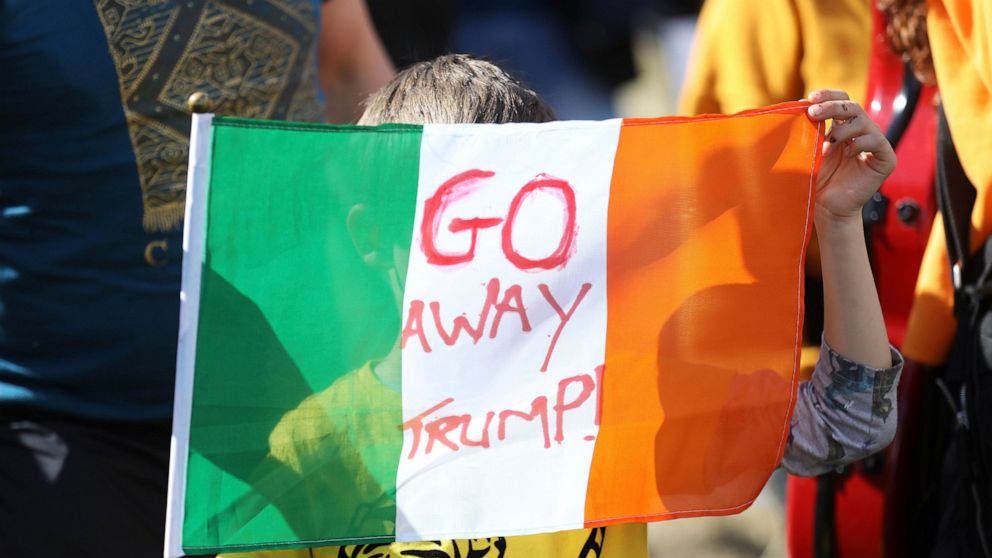 A demonstrator protests before the arrival of U.S President Trump at Shannon Airport in the west of Ireland, Wednesday, June 5, 2019. President Trump is staying overnight in Ireland before attending 75th anniversary of the D-Day landings events in no
