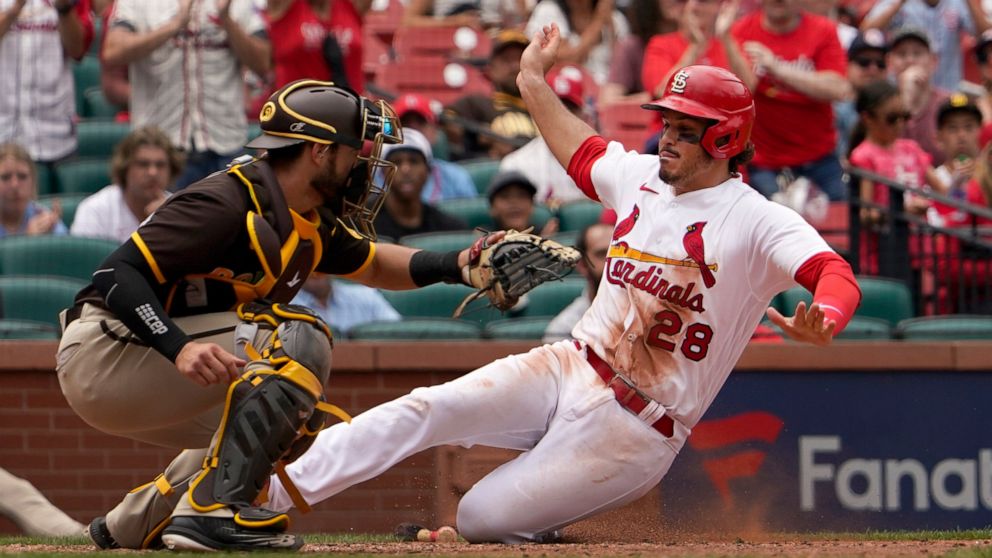 St. Louis Cardinals' Nolan Arenado (28) scores past San Diego Padres catcher Austin Nola during the eighth inning of a baseball game Wednesday, June 1, 2022, in St. Louis. (AP Photo/Jeff Roberson)