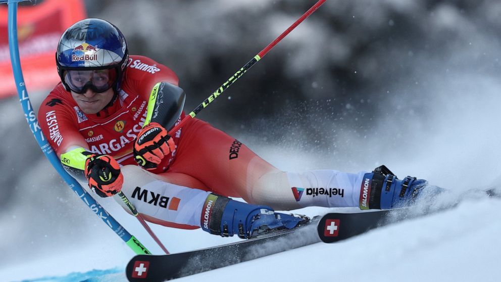 Switzerland's Marco Odermatt speeds down the course during an alpine ski, men's World Cup giant slalom, in Alta Badia, Italy, Sunday, Dec. 18, 2022. (AP Photo/Gabriele Facciotti)