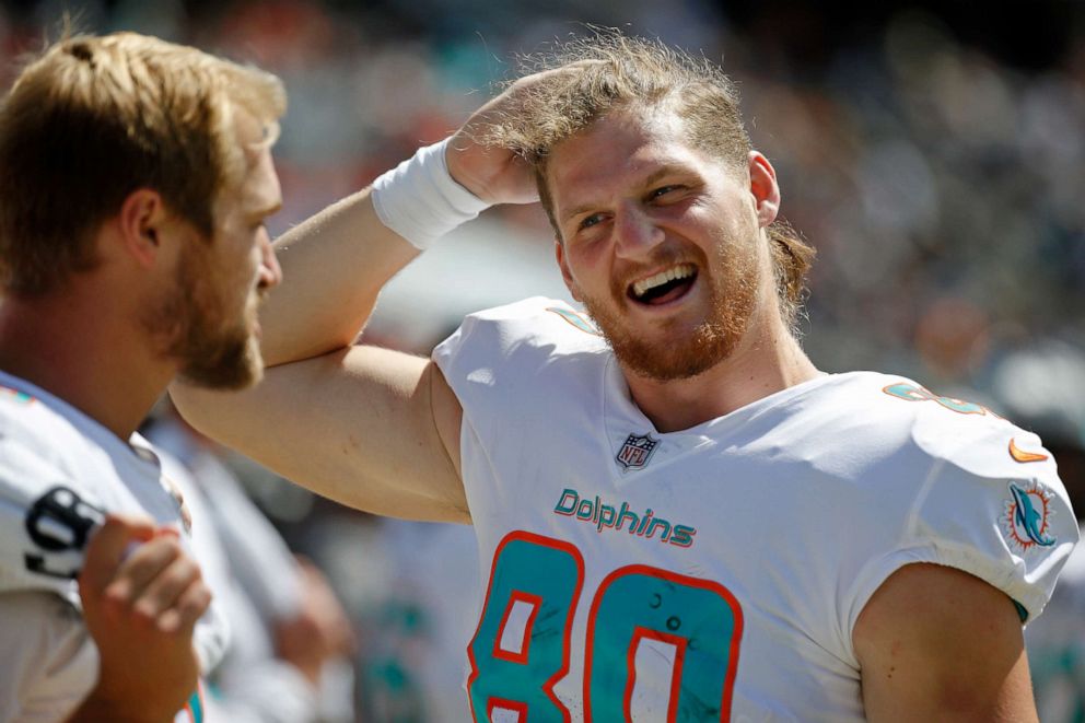 PHOTO: Miami Dolphins tight end Adam Shaheen, right, talks with tight end Mike Gesicki on the sideline during the second half against the Chicago Bears at Soldier Field in Chicago, Aug. 14, 2021.