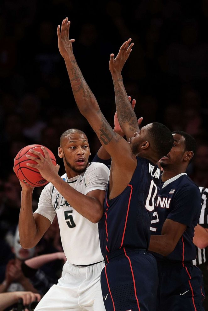PHOTO: Adreian Payne  of the Michigan State Spartans handles the ball against Phillip Nolan of the Connecticut Huskies at Madison Square Garden in New York,  March 30, 2014.