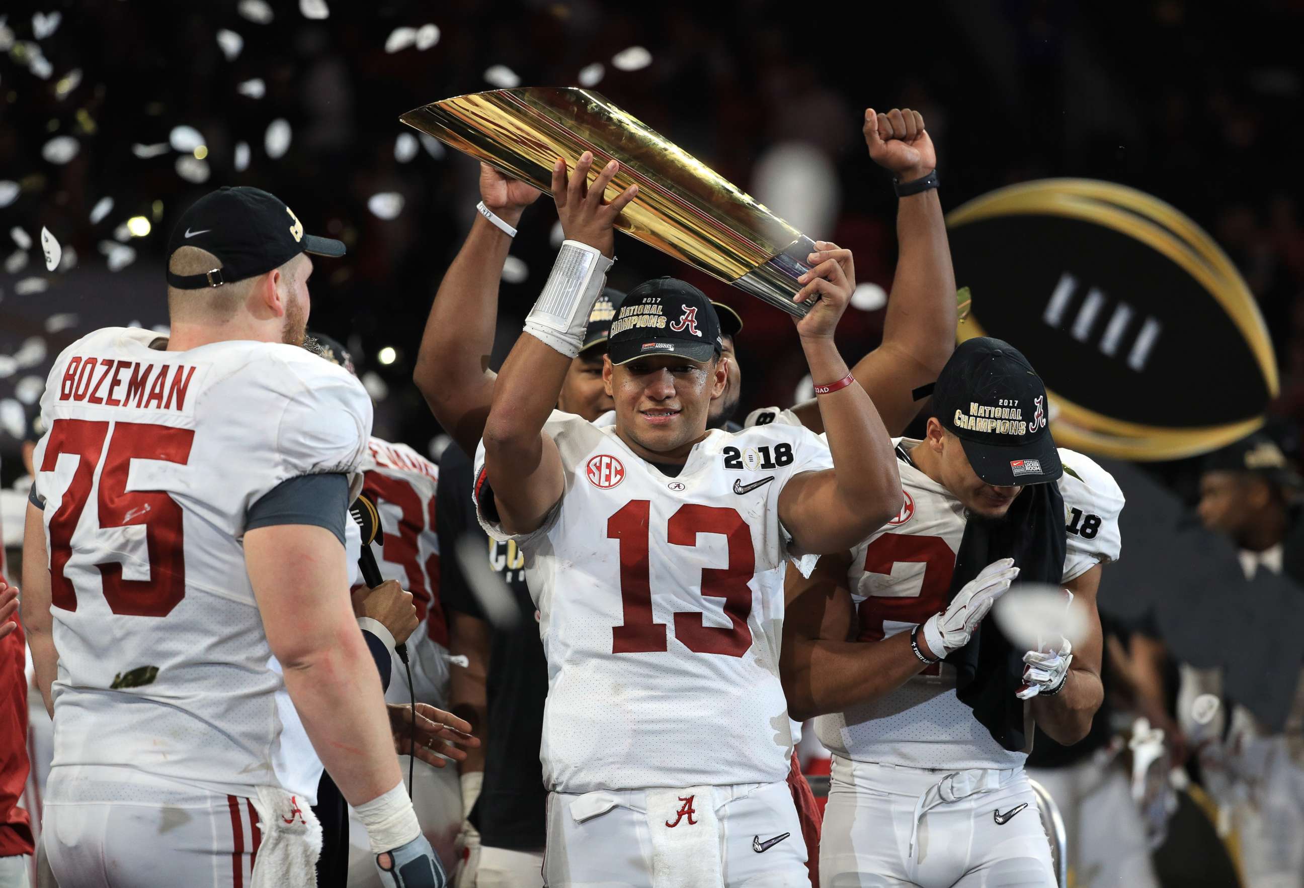 PHOTO: Tua Tagovailoa of the Alabama Crimson Tide holds the trophy while celebrating with his team after defeating the Georgia Bulldogs in overtime to win the CFP National Championship presented by AT&T at Mercedes-Benz Stadium, Jan. 8, 2018, in Atlanta.