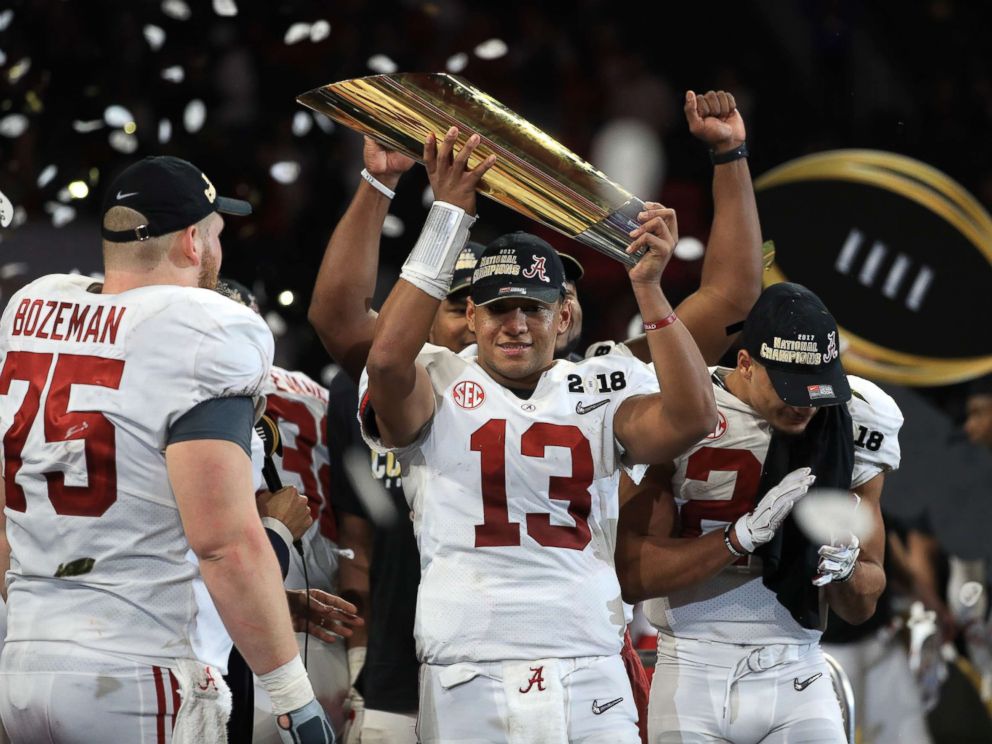 PHOTO: Tua Tagovailoa of the Alabama Crimson Tide holds the trophy while celebrating with his team after defeating the Georgia Bulldogs in overtime to win the CFP National Championship presented by AT&T at Mercedes-Benz Stadium, Jan. 8, 2018, in Atlanta.
