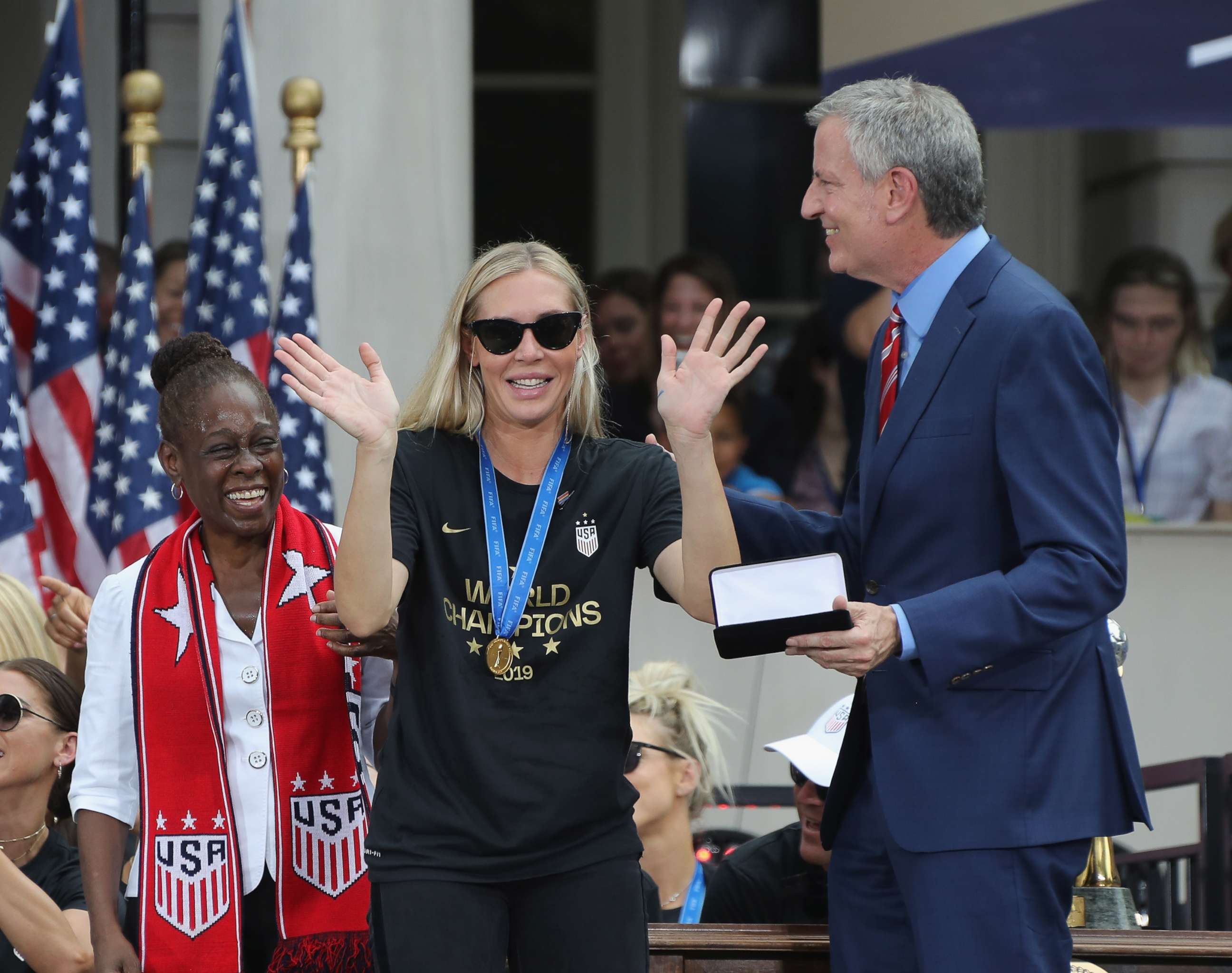 PHOTO: Allie Long of the United States Women's National Soccer Team receives the key to the city from Chirlane McCray, left, and Mayor Bill de Blasio, right, during a ceremony at City Hall on July 10, 2019 in New York City. 