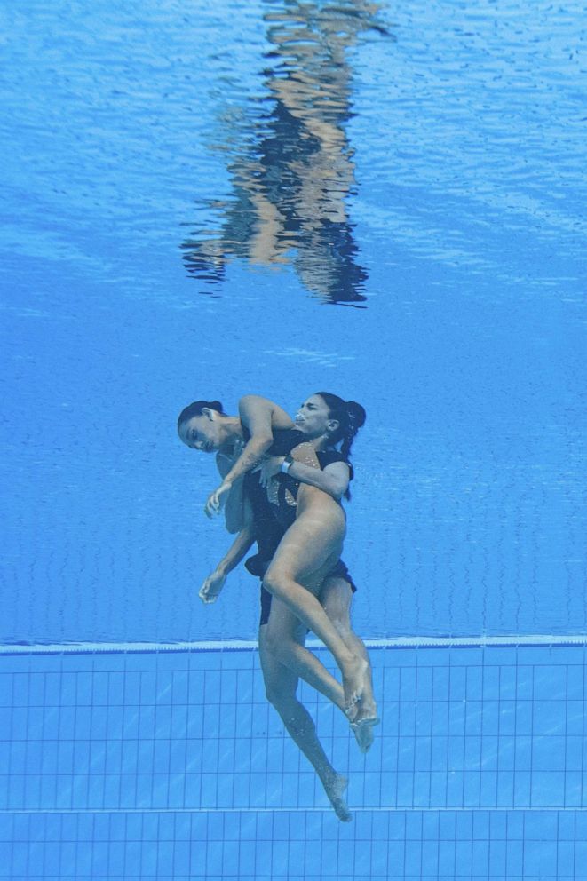 PHOTO: A member of the USA team picks up American Anita Alvarez from the bottom of the pool during an incident during the Women's Freestyle Solo Artistic Swimming final at the Budapest 2022 World Aquatics Championships in Budapest on 22 June 2022.