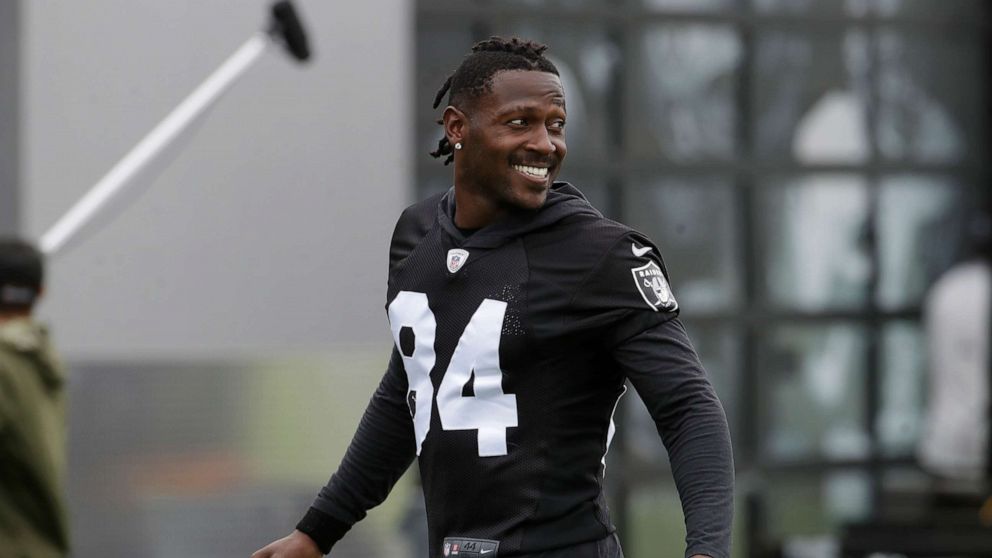 PHOTO: Oakland Raiders' Antonio Brown smiles before stretching during NFL football practice in Alameda, Calif.