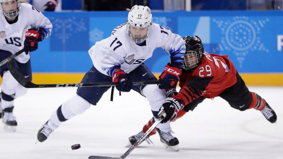 Jocelyne Lamoureux-Davidson (17), of the United States, and Marie-Philip Poulin (29), of Canada, compete for the puck during the second period of a preliminary round during a women's hockey game at the 2018 Winter Olympics in Gangneung, South Korea, Thursday, Feb. 15, 2018.