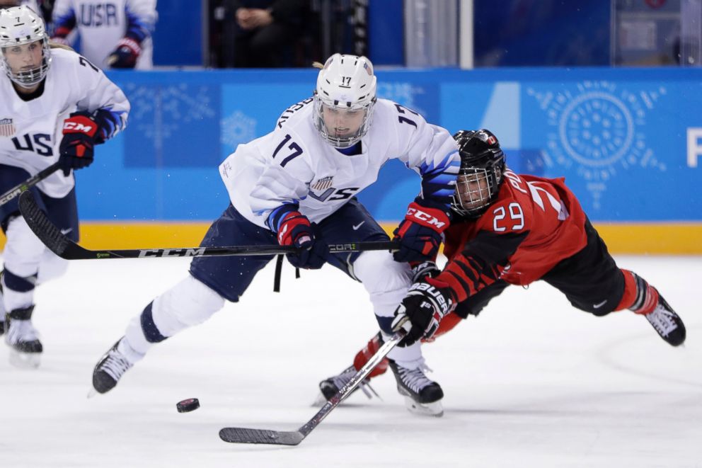 Jocelyne Lamoureux-Davidson (17), of the United States, and Marie-Philip Poulin (29), of Canada, compete for the puck during a preliminary round during a women's hockey game at the 2018 Winter Olympics in Gangneung, South Korea, Feb. 15, 2018.