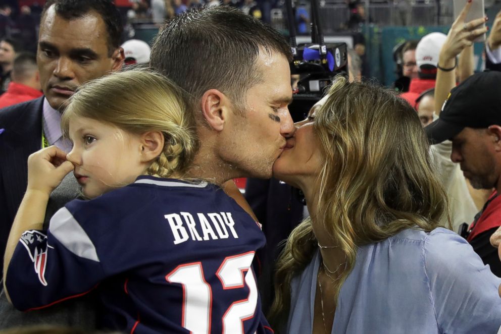 New England Patriots' Tom Brady kisses his wife Gisele Bundchen after his team defeated the Atlanta Falcons in overtime at the NFL Super Bowl 51.