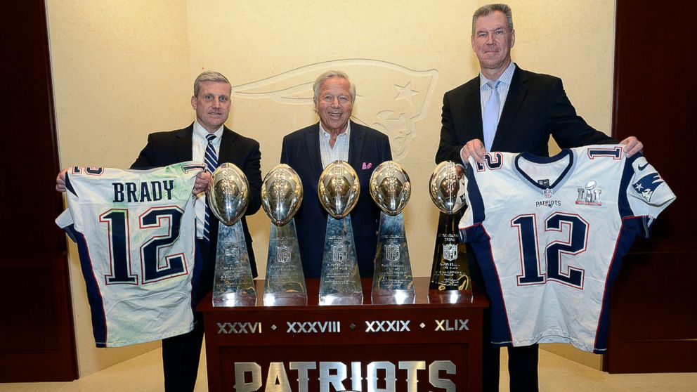 PHOTO: Harold H. Shaw, left, Special Agent in Charge of the FBI Boston Division and Colonel Richard D. McKeon, right, of the Massachusetts State Police, hold two recovered jerseys worn by Tom Brady, team owner Robert Kraft, center, March 23, 2017.