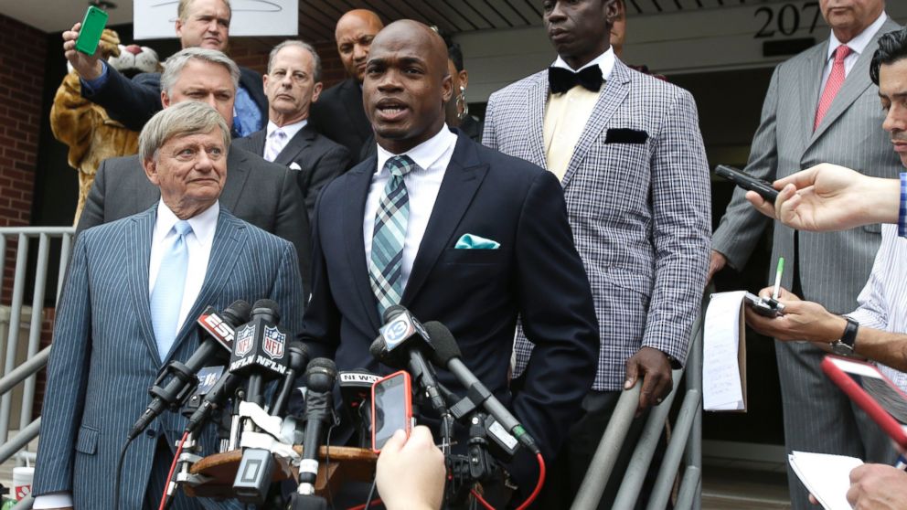 PHOTO: Minnesota Vikings running back Adrian Peterson and his attorney Rusty Hardin speak to the media after pleading no contest to an assault charge, Nov. 4, 2014, in Conroe, Texas.