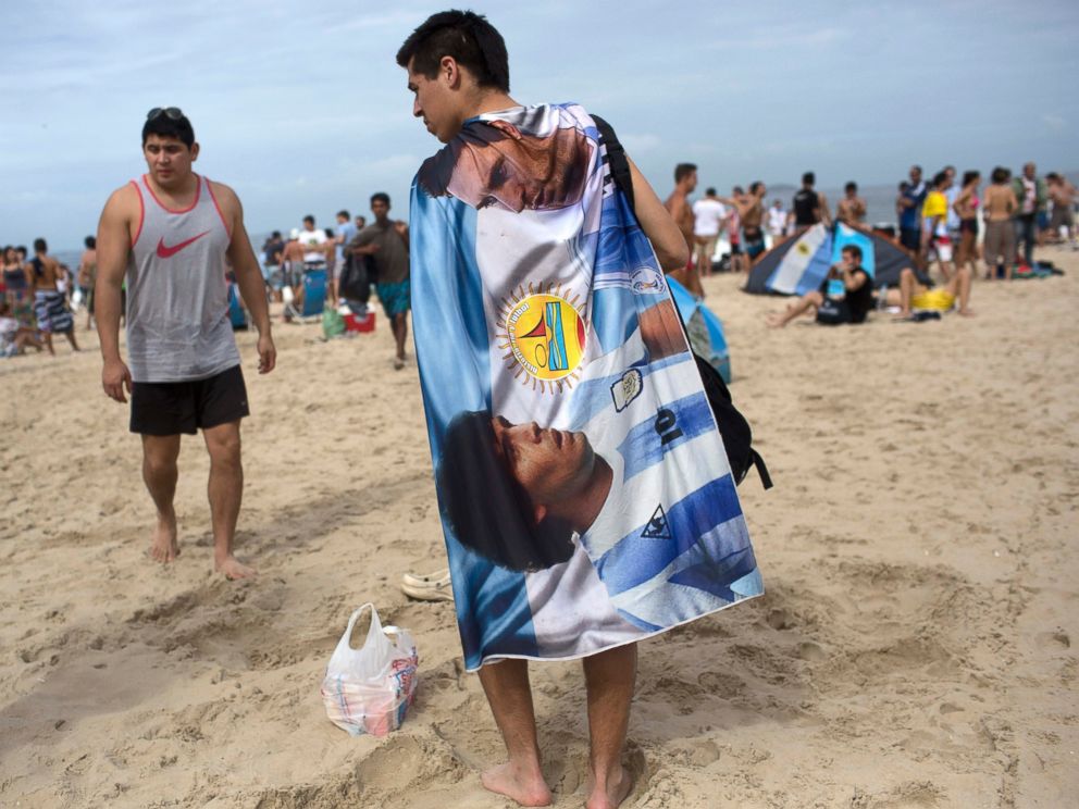 PHOTO: A soccer fan wears a banner designed with images of Diego Maradona and Lionel Messi, on Copacabana Beach in Rio de Janeiro, Brazil, July 12, 2014.