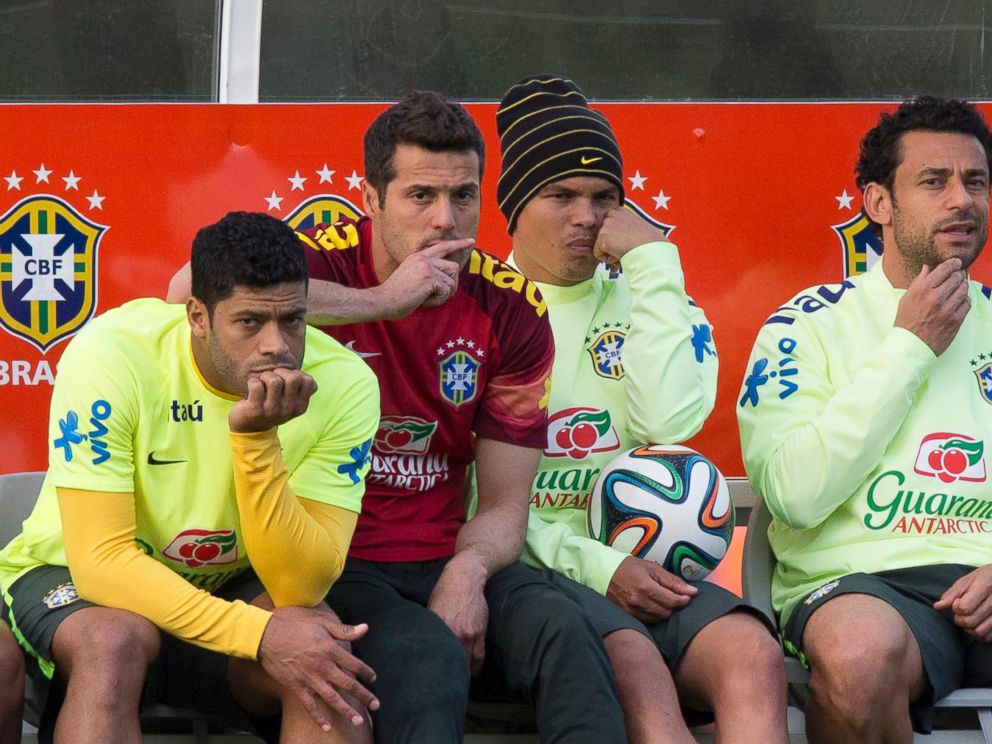PHOTO: Brazil national soccer team members, from left, Hulk, Julio Cesar, Thiago Silva and Fred, watch other teammates train during a practice session at the Granja Comary training center, in Teresopolis, Brazil, July 6, 2014.