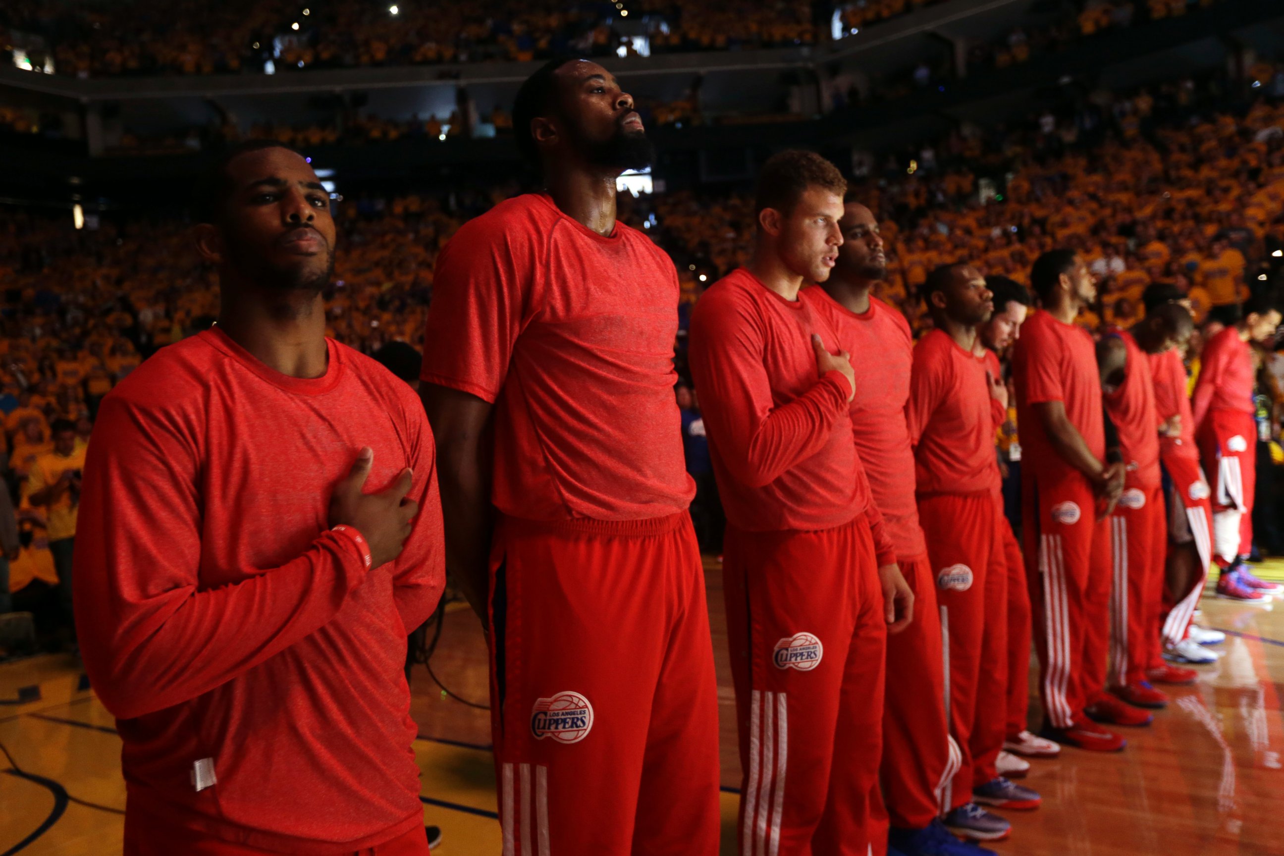PHOTO: Members of the Los Angeles Clippers listen to the national anthem before Game 4 of an opening-round NBA basketball playoff series against the Golden State Warriors on Sunday, April 27, 2014, in Oakland, Calif.