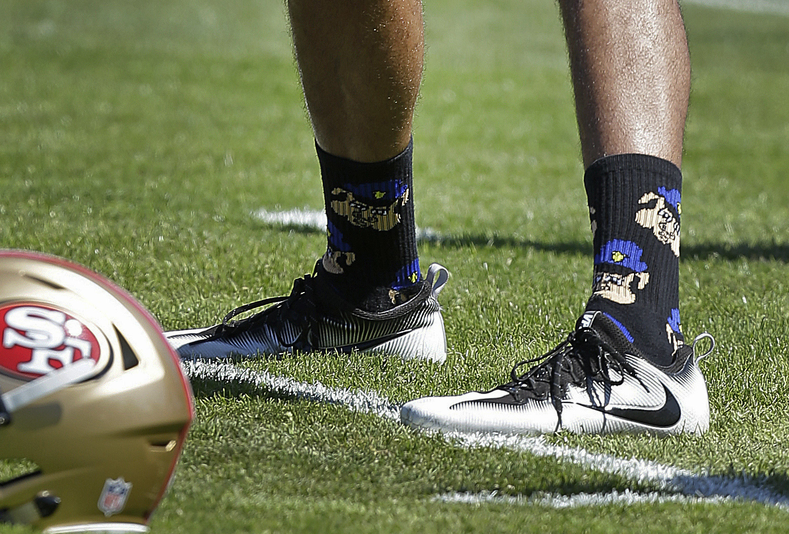 PHOTO: San Francisco 49ers quarterback Colin Kaepernick wears socks depicting police officers as pigs during NFL football training camp at Kezar Stadium in San Francisco, Aug. 10, 2016.