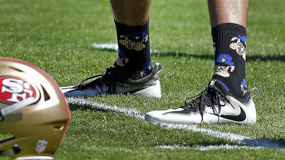 San Francisco 49ers quarterback Colin Kaepernick wears socks depicting police officers as pigs during NFL football training camp at Kezar Stadium in San Francisco, Aug. 10, 2016.