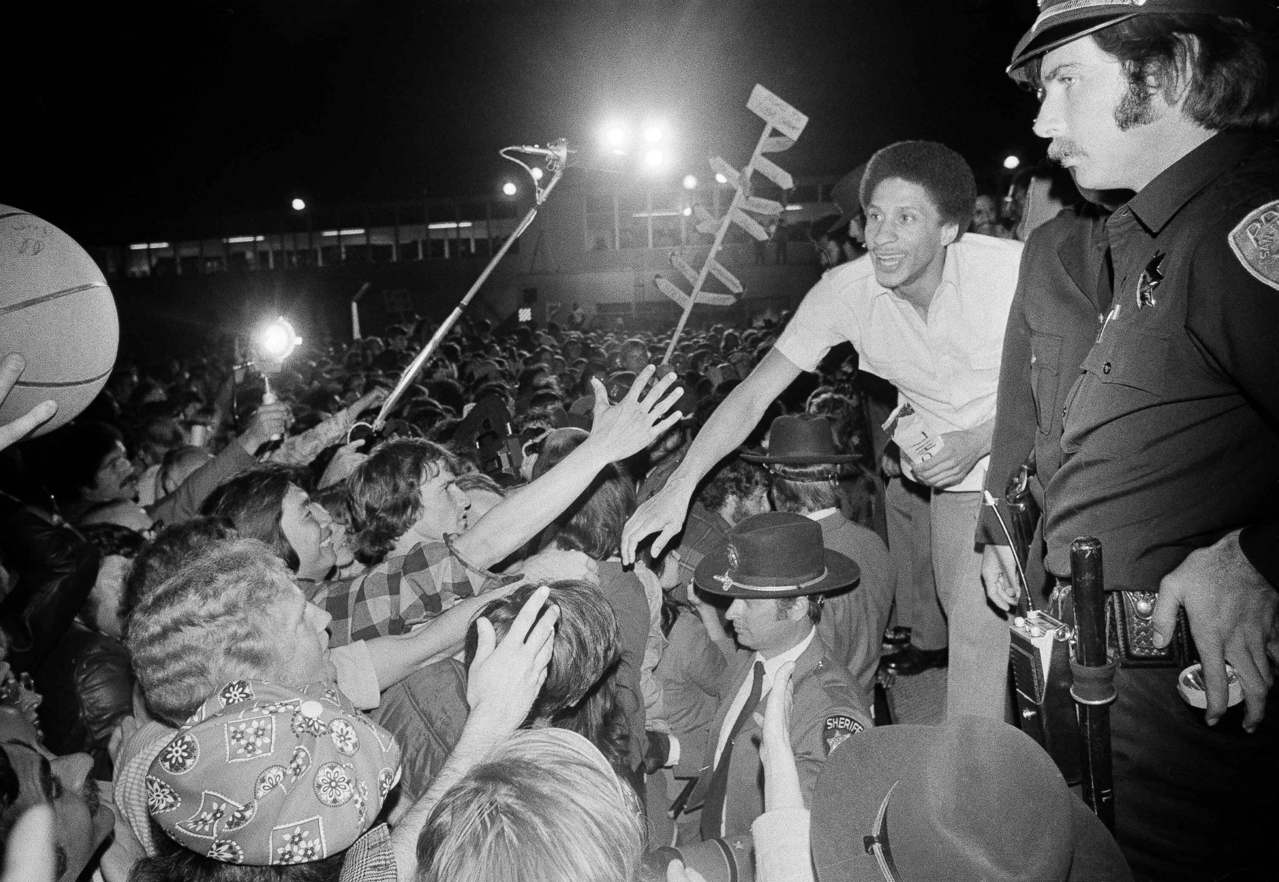 PHOTO: Golden State Warrior Phil Smith, right, gets a hearty reception at San Francisco Airport as the Warriors returned from winning the NBA Championship in Landover, Maryland over the Washington Bullets, May 26, 1975,