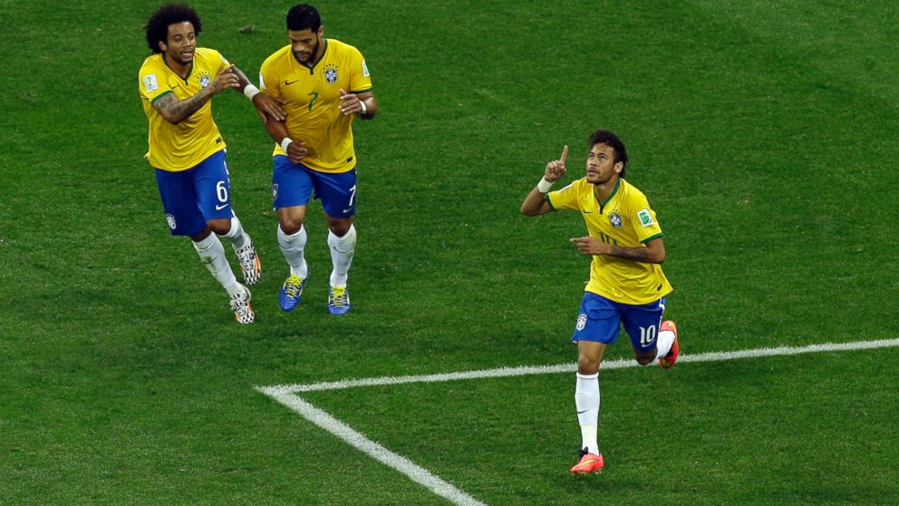 Brazil's Neymar, right, celebrates scoring his side's first goal during the group A World Cup soccer match between Brazil and Croatia, the opening game of the tournament, in the Itaquerao Stadium in Sao Paulo, Brazil, June 12, 2014. 