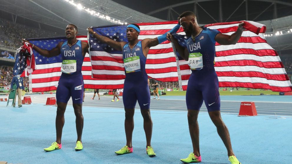 Members of the United States team from left, United States' Justin Gatlin, United States' Mike Rodgers and United States' Tyson Gay celebrate after the men's 4x100-meter relay final during the athletics competitions of the 2016 Summer Olympics at the Olympic stadium in Rio de Janeiro, Brazil, Friday, Aug. 19, 2016.