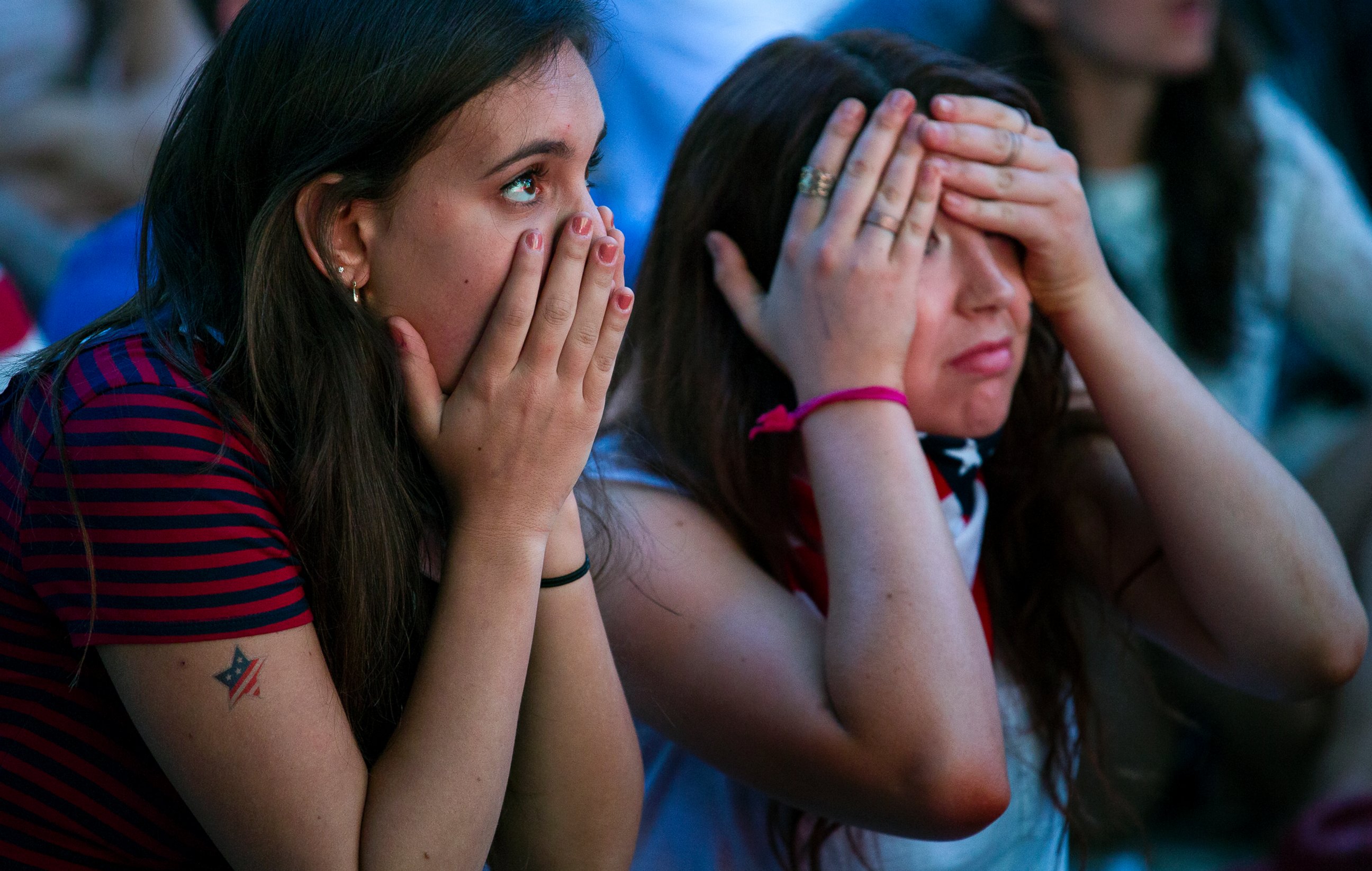 PHOTO: Allison DiFilippo, left, and Samantha Donat, both of New York, react to a last-minute goal at the end of their 2014 World Cup Group G soccer match, while watching a large screen broadcast on Governor's Island in New York, June 22, 2014. 