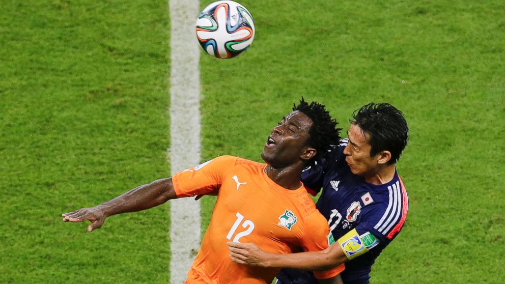 Japan's Makoto Hasebe, right, and Ivory Coast's Wilfried Bony go for a header during the group C World Cup soccer match between Ivory Coast and Japan at the Arena Pernambuco in Recife, Brazil, Saturday, June 14, 2014.