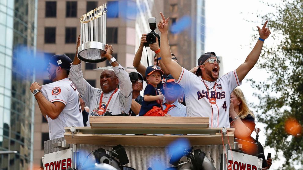PHOTO: Houston Mayor Sylveter Turner, left,holds up the World Series trophy as the Houston Astros World Series MVP George Springer (4) cheers during  parade honoring the World Series baseball champions, Nov. 3, 2017, in Houston.