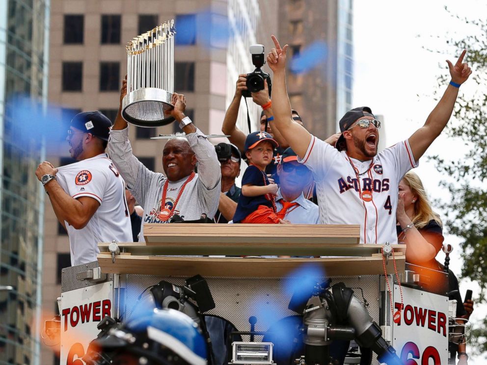 PHOTO: Houston Mayor Sylveter Turner, left,holds up the World Series trophy as the Houston Astros World Series MVP George Springer (4) cheers during parade honoring the World Series baseball champions, Nov. 3, 2017, in Houston.