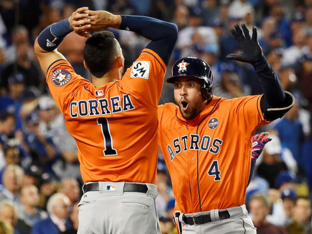 PHOTO: Houston Astros center fielder George Springer celebrates with shortstop Carlos Correa after hitting a two-run home run against the Los Angeles Dodgers in the second inning in game seven of the 2017 World Series at Dodger Stadium. 