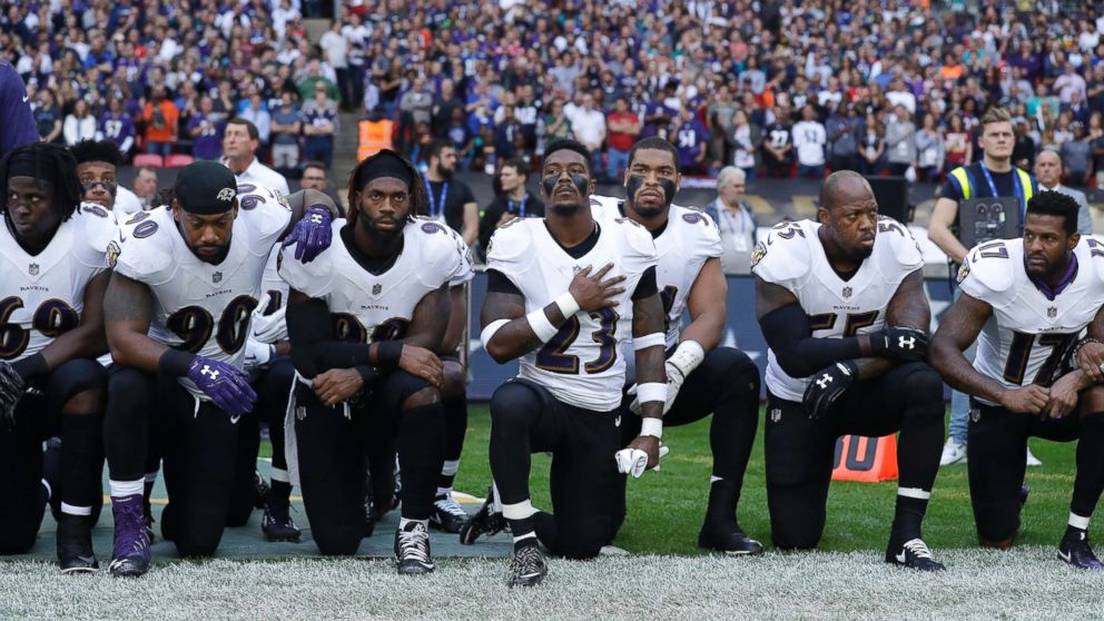 Baltimore Ravens players kneel down during the playing of the U.S. national anthem before an NFL football game against the Jacksonville Jaguars at Wembley Stadium in London, Sept. 24, 2017. 