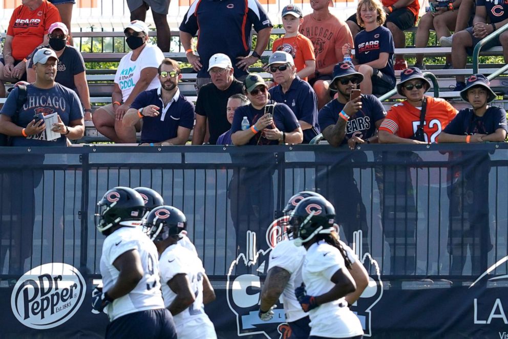 PHOTO: Chicago Bears fans watch players during NFL football practice in Lake Forest, Ill., July 29, 2021.