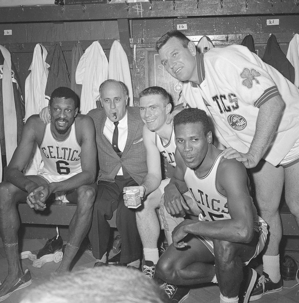 PHOTO: In this April 9, 1964, file photo, Boston Celtics, from left, Bill Russell, coach Red Auerbach, Tommy Heinsohn, Jim Locustoff and K.C. Jones celebrate after clinching their eighth straight Eastern Division playoff title at the Boston Garden. 