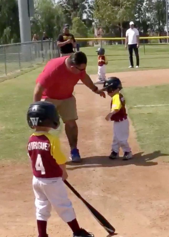 Funny kid baseball player in baseball helmet and baseball bat